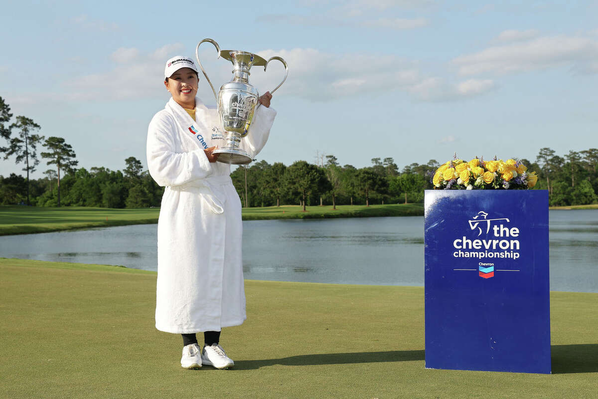 Mao Saigo of Japan poses with the trophy after taking her championship leap at The Chevron Championship 2025 in a playoff at The Club at Carlton Woods on April 27, 2025 in The Woodlands, Texas. 