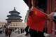 A child holds a Chinese national flag near the Hall of Prayer for Good Harvests at the Temple of Heaven in Beijing, China, Friday, April 3, 2026.