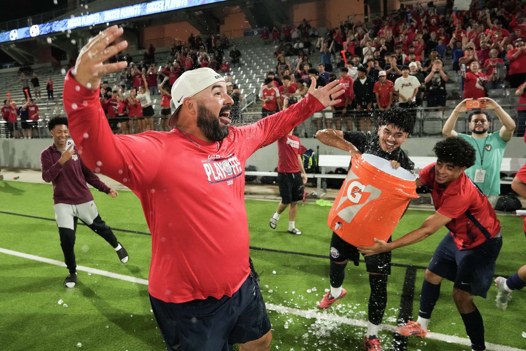 Atascocita head coach Jed Garner reacts after being dunked with water after the team’s Class 6A boy UIL state semifinal win over Cibolo Steele to advance to the championship match at Cy-Fair FCU Stadium, Friday, April 3, 2026, in Cy-Fair.