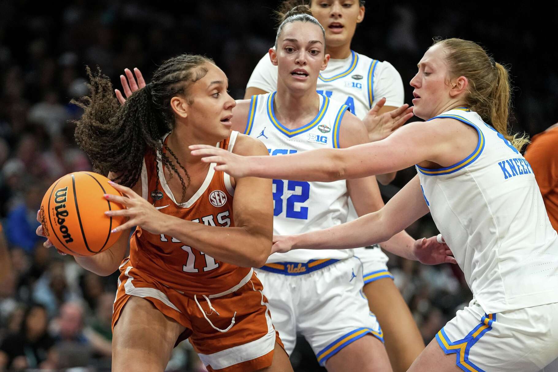 Texas Longhorns forward Justice Carlton (11) is guarded during the NCAA Final Four game against UCLA at the Mortgage Matchup Center on Friday, April 3, 2026 in Phoenix, Arizona.