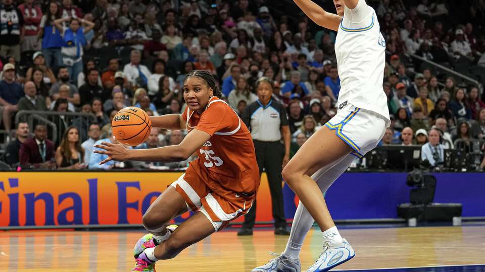 Texas Longhorns forward Madison Booker (35) rolls her ankle and falls while pushing past UCLA center Lauren Betts (51) during the NCAA Final Four game at the Mortgage Matchup Center on Friday, April 3, 2026 in Phoenix, Arizona.