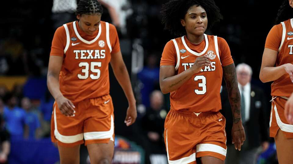 Texas Longhorns guard Rori Harmon (3) and forward Madison Booker (35) leave the court during a timeout in the NCAA Final Four game against UCLA at the Mortgage Matchup Center on Friday, April 3, 2026 in Phoenix, Arizona.