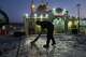 A worker cleans an area within the Grand Hosseiniyeh complex, with the mosque visible in the background, that officials say was hit by U.S.-Israeli airstrikes Tuesday in Zanjan, Iran, Saturday, April 4, 2026.