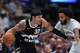Denver Nuggets forward Aaron Gordon, left, looks to pass the ball as San Antonio Spurs forward Julian Champagnie defends in the first half of an NBA basketball game Saturday, April 4, 2026, in Denver. (AP Photo/David Zalubowski)