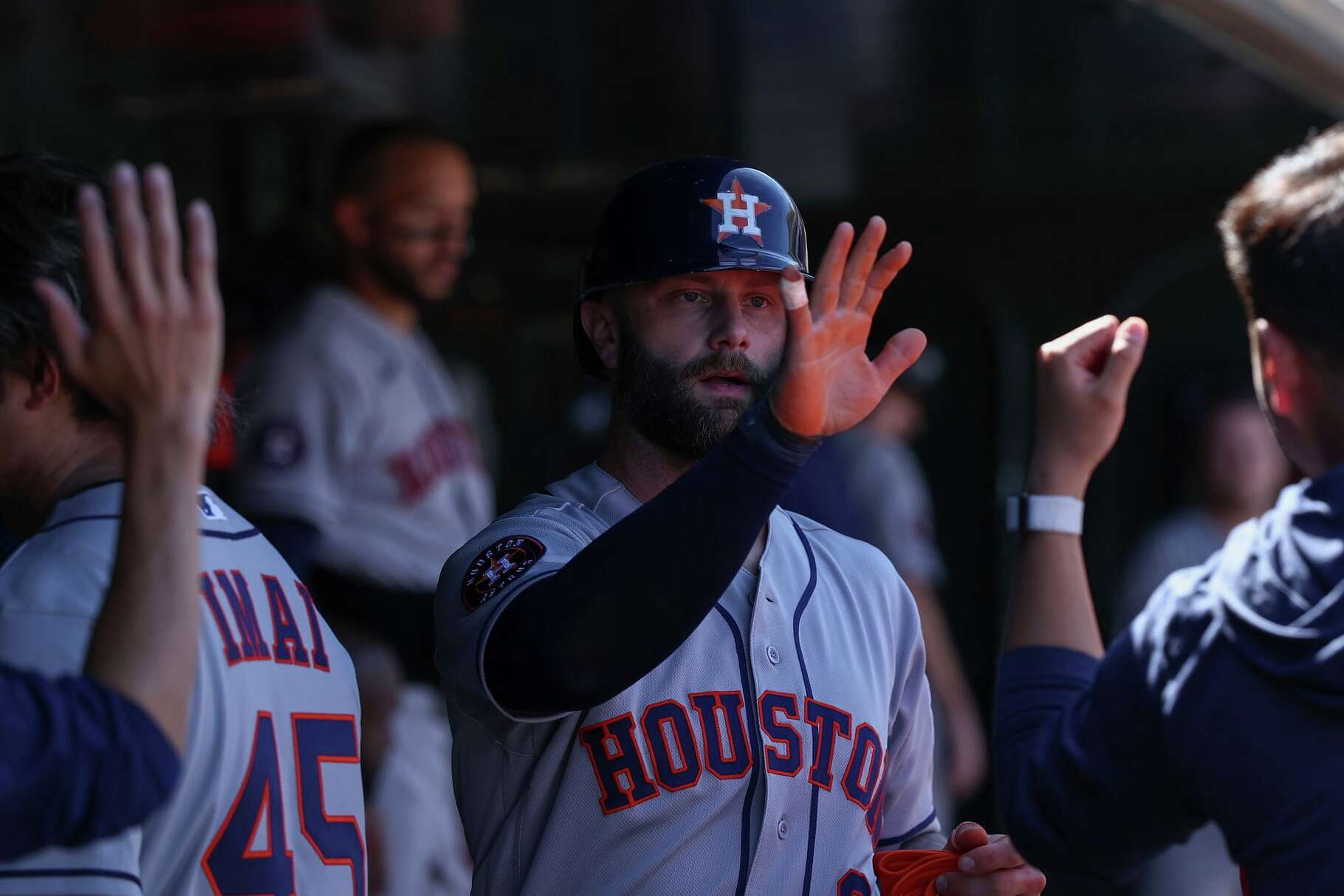 Houston Astros' Christian Walker, center, celebrates in the dugout after scoring during the sixth inning of a baseball game against the Athletics, Saturday, April 4, 2026, in West Sacramento, Calif. (AP Photo/Sara Nevis)