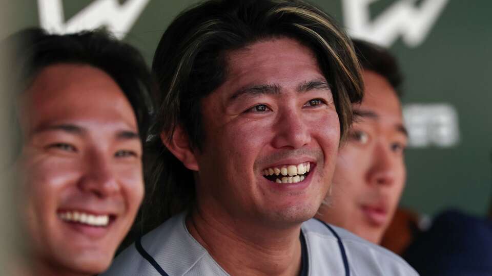 Houston Astros pitcher Tatsuya Imai, center, smiles in the dugout during the third inning of a baseball game against the Athletics, Saturday, April 4, 2026, in West Sacramento, Calif. (AP Photo/Sara Nevis)