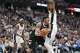 Denver Nuggets forward Aaron Gordon, left, drives under San Antonio Spurs center Victor Wembanyama in the second half of an NBA basketball game Saturday, April 4, 2026, in Denver. (AP Photo/David Zalubowski)