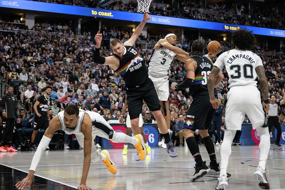 The San Antonio Spurs' Victor Wembanyama, left, and the Denver Nuggets' Nikola Jokic (15) come down hard during the first half at Ball Arena on Saturday, April 4, 2026, in Denver. (Photo by Timothy Hurst/The Denver Post/TNS)