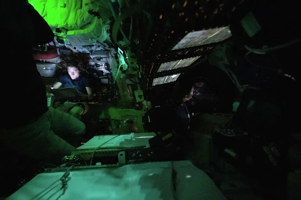 In this handout image provided by NASA, NASA astronaut Christina Koch is illuminated by a screen inside the darkened Orion spacecraft on the third day of the agency's Artemis II mission on April 3, 2026.