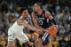 Michigan's Yaxel Lendeborg (23) and UConn's Jayden Ross battle for the ball during the first half of the NCAA college basketball tournament national championship game at the Final Four, Monday, April 6, 2026, in Indianapolis. (AP Photo/Michael Conroy)