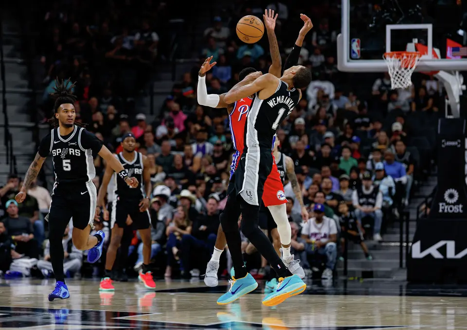 San Antonio Spurs forward Victor Wembanyama (1) and Philadelphia 76ers forward Paul George (8) collide during the second quarter of an NBA game at Frost Bank Center in San Antonio, Monday, April 6, 2026. Wembanyama sat out in the second half of the game due to a left rib contusion.
