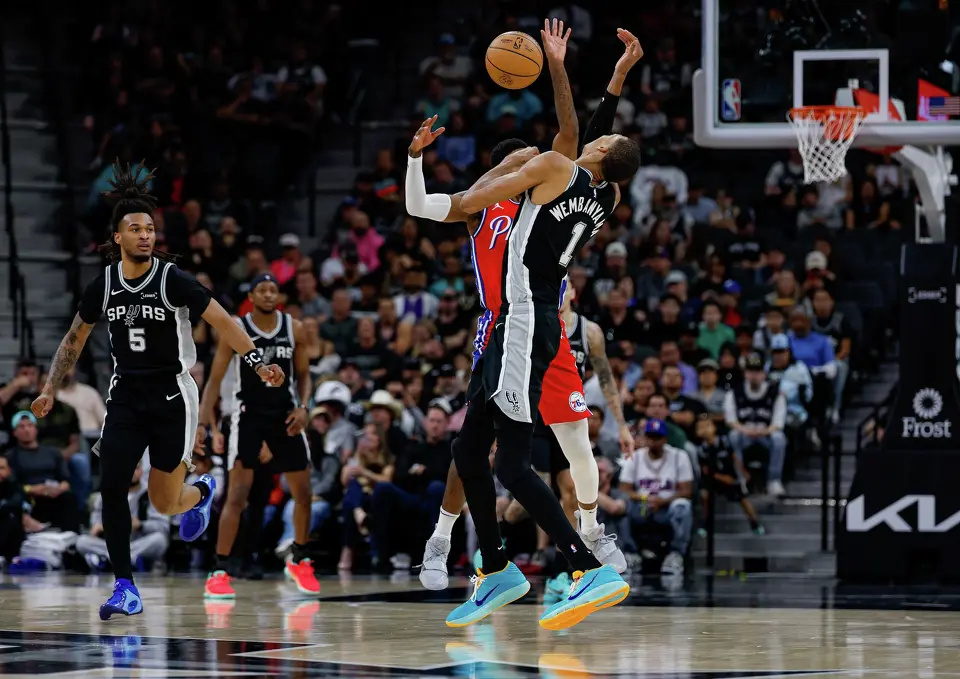 San Antonio Spurs forward Victor Wembanyama (1) and Philadelphia 76ers forward Paul George (8) collide during the second quarter of an NBA game at Frost Bank Center in San Antonio, Monday, April 6, 2026. Wembanyama sat out in the second half of the game due to a left rib contusion.
