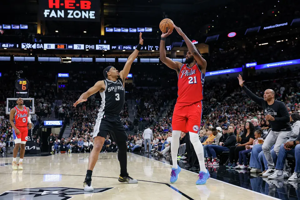 Philadelphia 76ers center Joel Embiid (21) shoots over San Antonio Spurs forward Keldon Johnson (3) during an NBA game at Frost Bank Center in San Antonio, Monday, April 6, 2026. The Spurs defeated the 76ers 115-102.