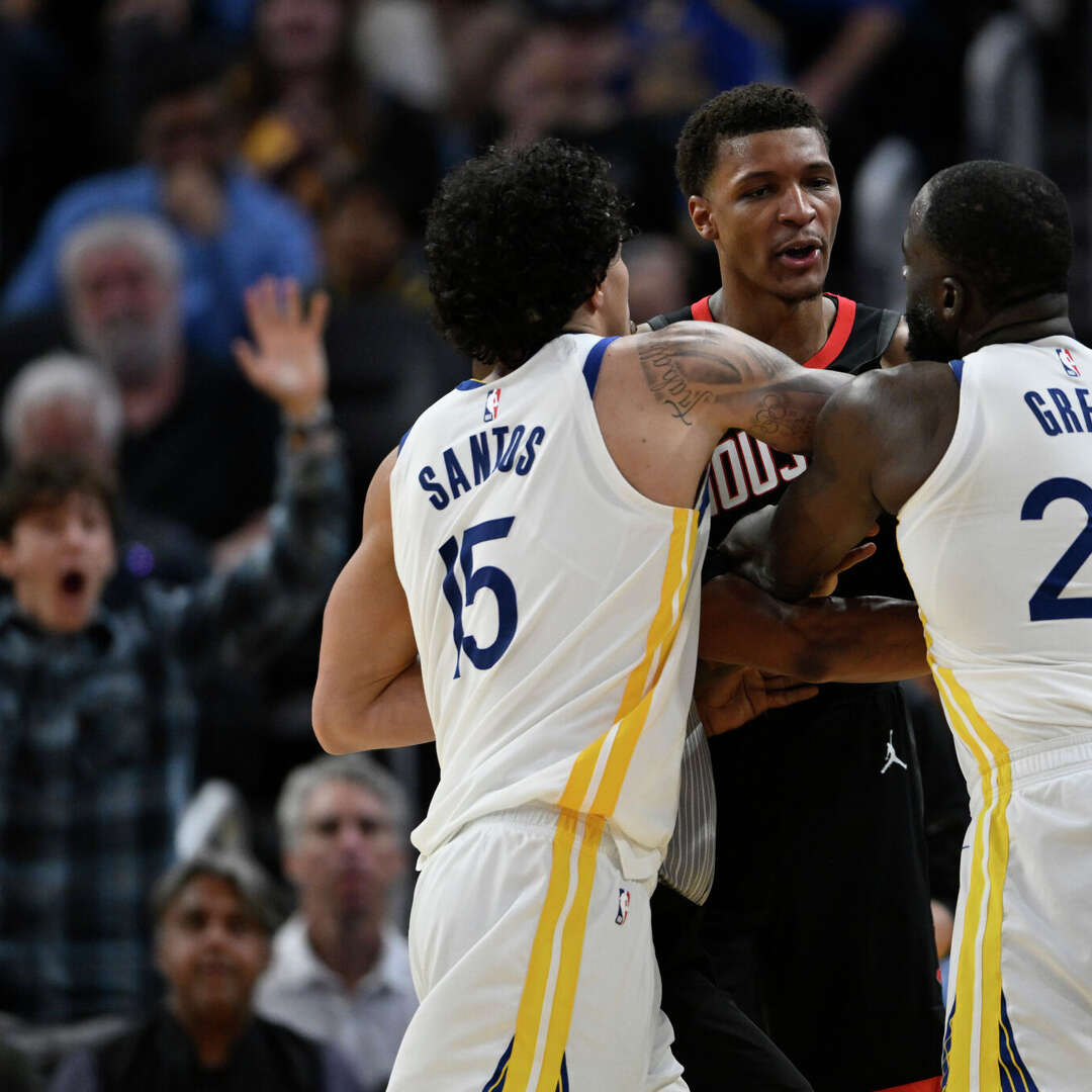 Gui Santos (15) of the Golden State Warriors attempts to break up an altercation between Draymond Green (23) and Jabari Smith Jr. (10) of the Houston Rockets in the third quarter at Chase Center on April 5, 2026 in San Francisco, California.