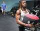 NFL hopeful Tyren Montgomery sprints with a sandbag while trainer Matt Johnson watches at Warrior Church Gym in Spring on Monday, April 6, 2026.