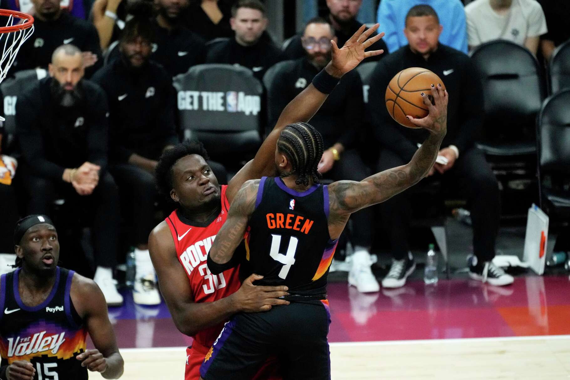 Houston Rockets center Clint Capela, left, fouls Phoenix Suns guard Jalen Green (4) during the second half of an NBA basketball game, Tuesday, April 7, 2026, in Phoenix. (AP Photo/Ross D. Franklin)