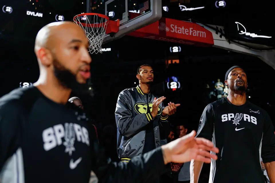 San Antonio Spurs forward Victor Wembanyama claps as the starting lineup is announced before an NBA game against the Portland Trail Blazers at Frost Bank Center, Wednesday, April 8, 2026, in San Antonio. Wembanyama did not play because of an injury sustained Monday night against the Philadelphia 76ers.