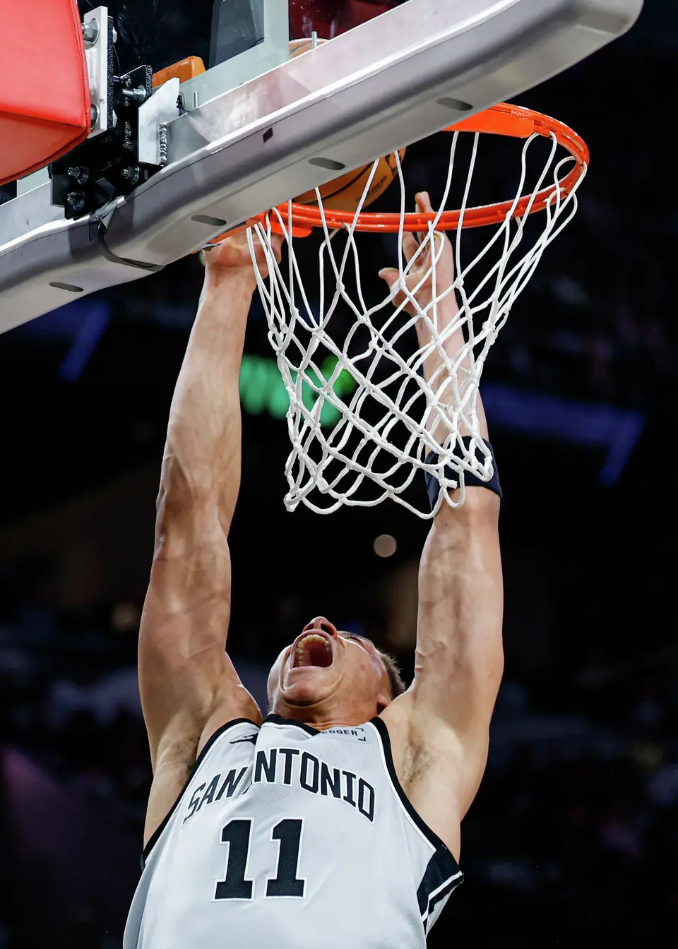 San Antonio Spurs forward Carter Bryant (11) dunks on the Portland Trail Blazers during the second quarter at Frost Bank Center in San Antonio, Wednesday, April 8, 2026.