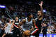 San Antonio Spurs guard De'aaron Fox (4) looks to make a pass against Portland Trail Blazers forward Toumani Camara during a home game at Frost Bank Center in San Antonio, Wednesday, April 8, 2026.