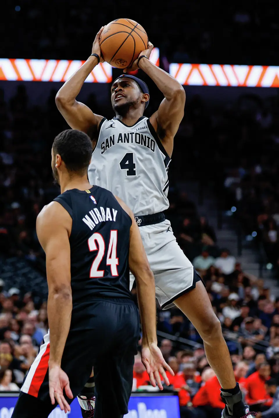 San Antonio Spurs guard De'aaron Fox (4) makes a jump shot over Portland Trail Blazers forward Kris Murray (24) during the second quarter at Frost Bank Center in San Antonio, Wednesday, April 8, 2026.