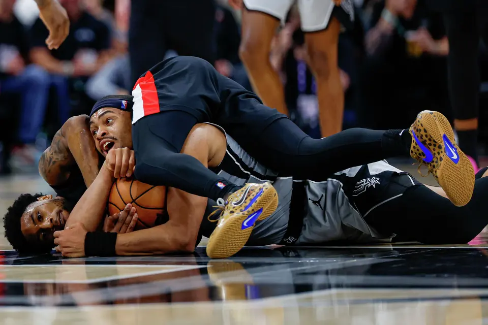 San Antonio Spurs forward Keldon Johnson (3) and Portland Trail Blazers guard Blake Wesley (1) tangle on the court during the second quarter at Frost Bank Center in San Antonio, Wednesday, April 8, 2026.