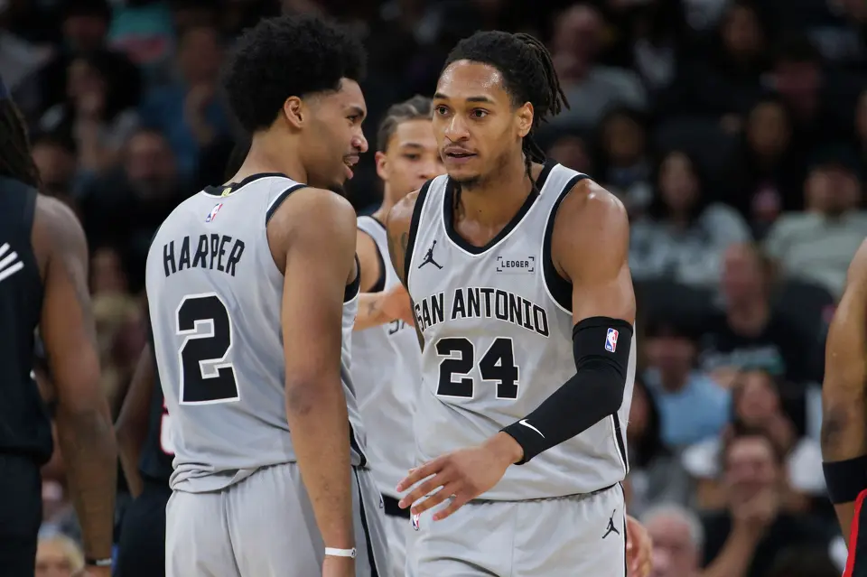 San Antonio Spurs guard Devin Vassell (24) celebrates a basket with teammate Dylan Harper during the first half of their NBA basketball game against the Portland Trail Blazers, Wednesday, April 8, 2026, in San Antonio.