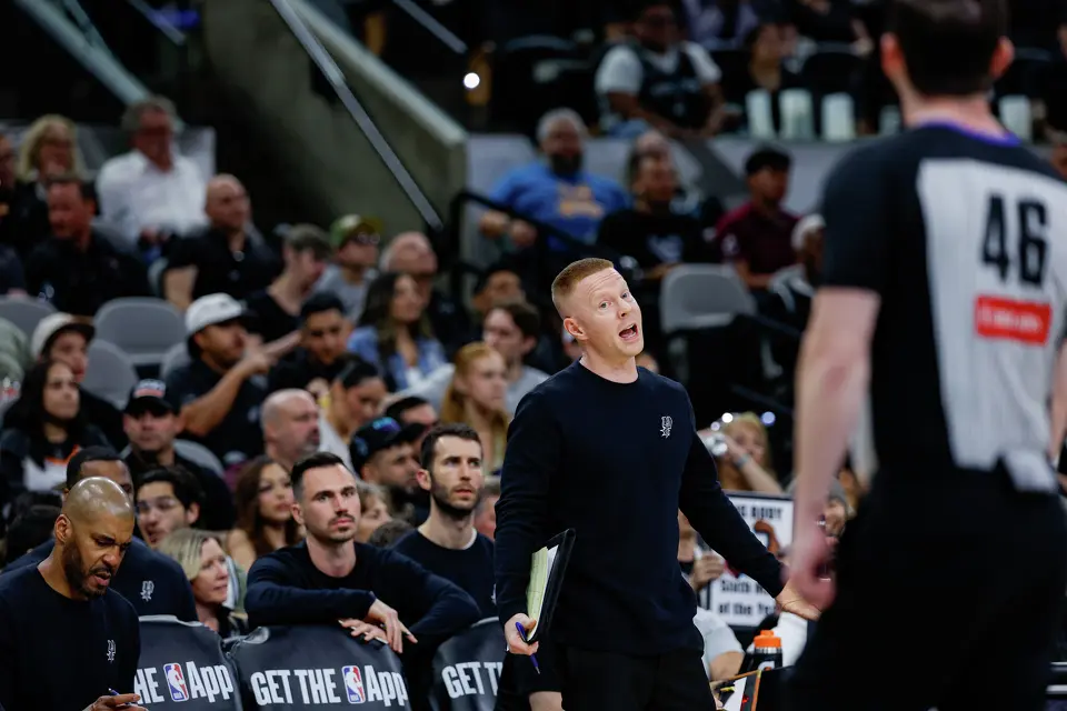 San Antonio Spurs associate head coach Sean Sweeney talks to referee Ben Taylor (46) during a game against the Portland Trail Blazers at Frost Bank Center in San Antonio, Wednesday, April 8, 2026.