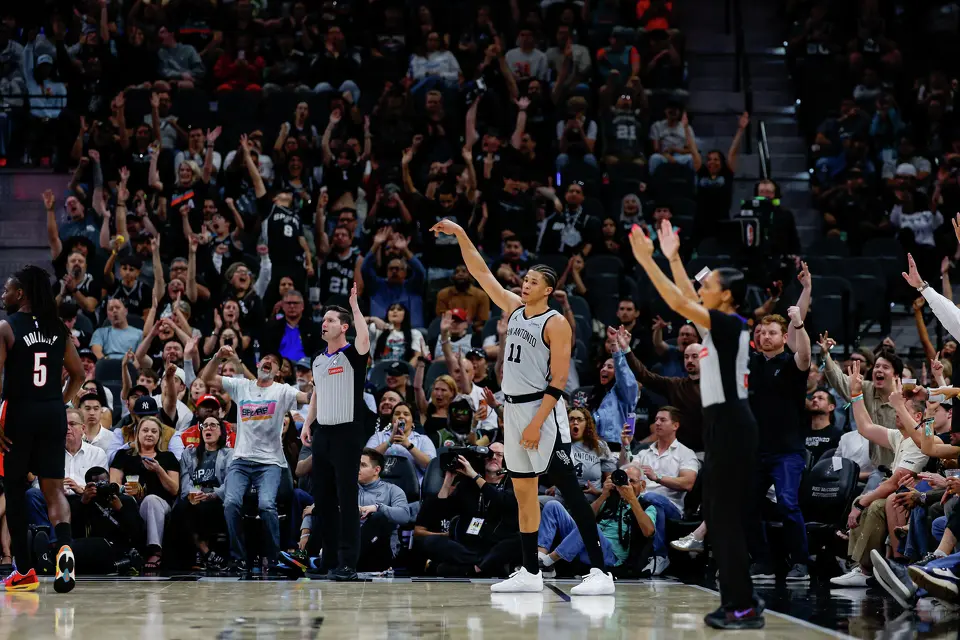 The crowd erupts as San Antonio Spurs forward Carter Bryant (11) makes a 3-pointer during the fourth quarter against the Portland Trail Blazers at Frost Bank Center in San Antonio, Wednesday, April 8, 2026. The Spurs defeated the Trail Blazers 112-101.