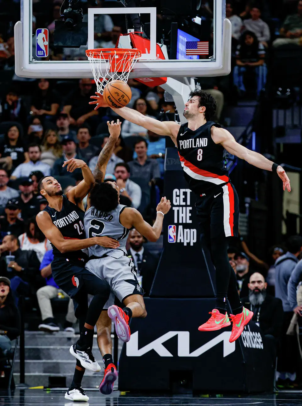 Portland Trail Blazers forward Kris Murray (24) and forward Deni Avdija (8) block San Antonio Spurs guard Dylan Harper (2) at the net during an NBA game at Frost Bank Center in San Antonio, Wednesday, April 8, 2026. The Spurs defeated the Trail Blazers 112-101.