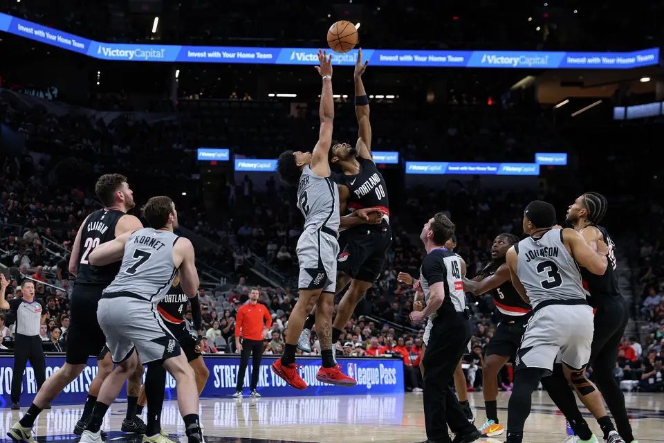 San Antonio Spurs guard Dylan Harper (2) and Portland Trail Blazers guard Scoot Henderson (00) battle for a jump ball at Frost Bank Center in San Antonio, Wednesday, April 8, 2026. The Spurs defeated the Trail Blazers 112-101.