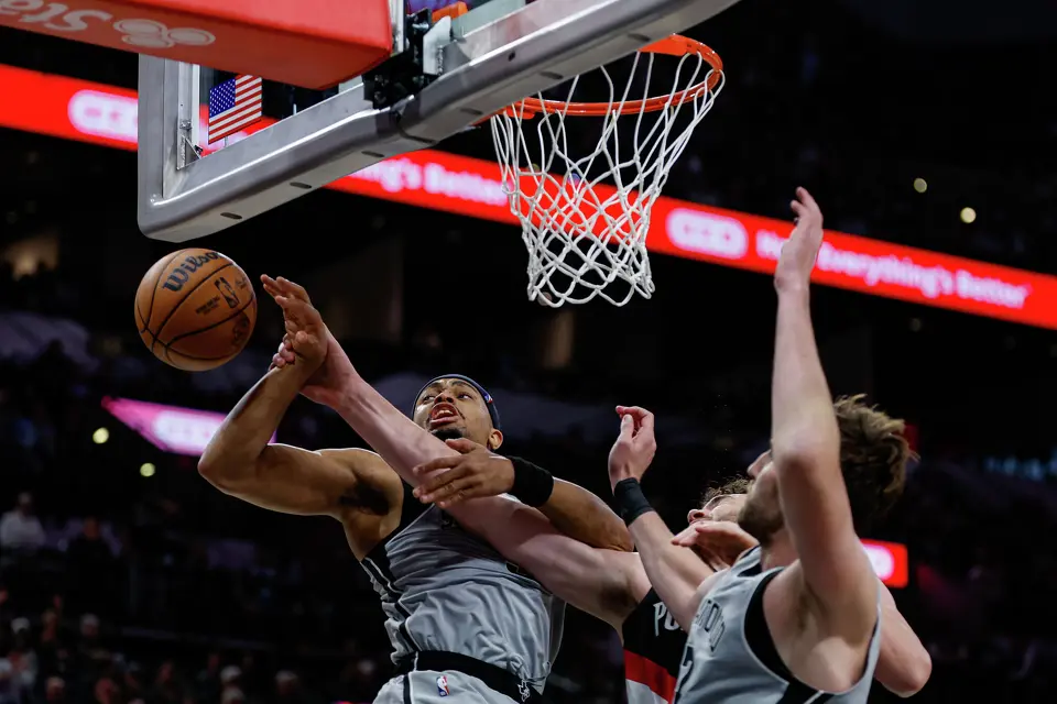San Antonio Spurs forward Victor Wembanyama (1) and center Luke Kornet (7) block Portland Trail Blazers center Donovan Clingan (23) under the net during an NBA game at Frost Bank Center in San Antonio, Wednesday, April 8, 2026. The Spurs defeated the Trail Blazers 112-101.