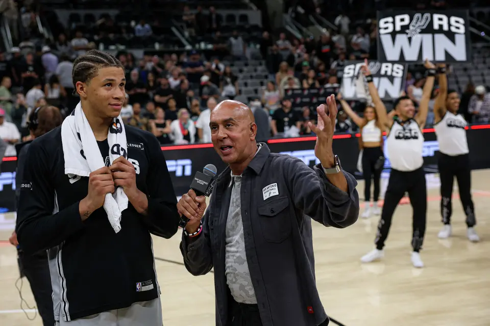 San Antonio Spurs forward Carter Bryant (11) talks with Chuck Cureau following the Spurs’ 112-101 win over the Portland Trail Blazers at Frost Bank Center in San Antonio, Wednesday, April 8, 2026. Bryant finished with 17 points, five rebounds, and four assists.