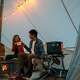 Couple camping using the Jackery Solar Generator 5000 Plus for their light source.
