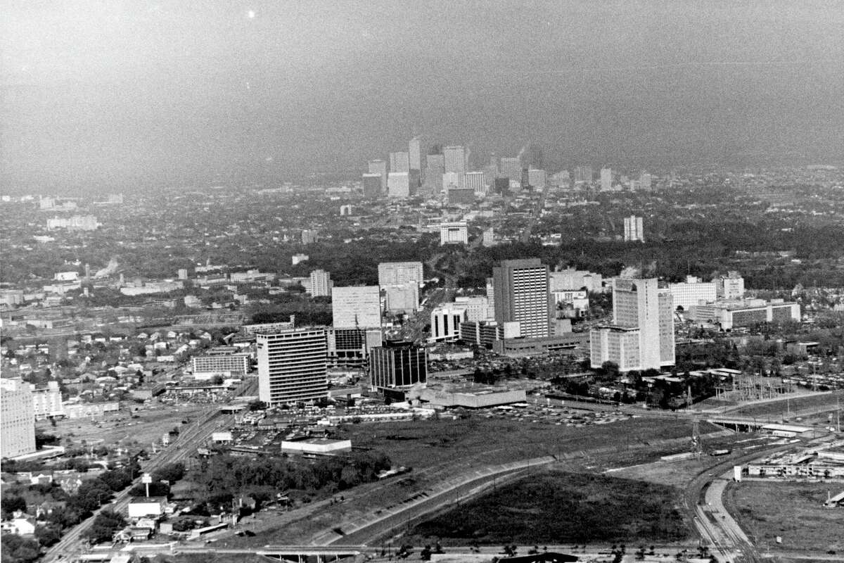 1970s - aerial of Texas Medical Center in Houston, Texas. Downtown skyline in background