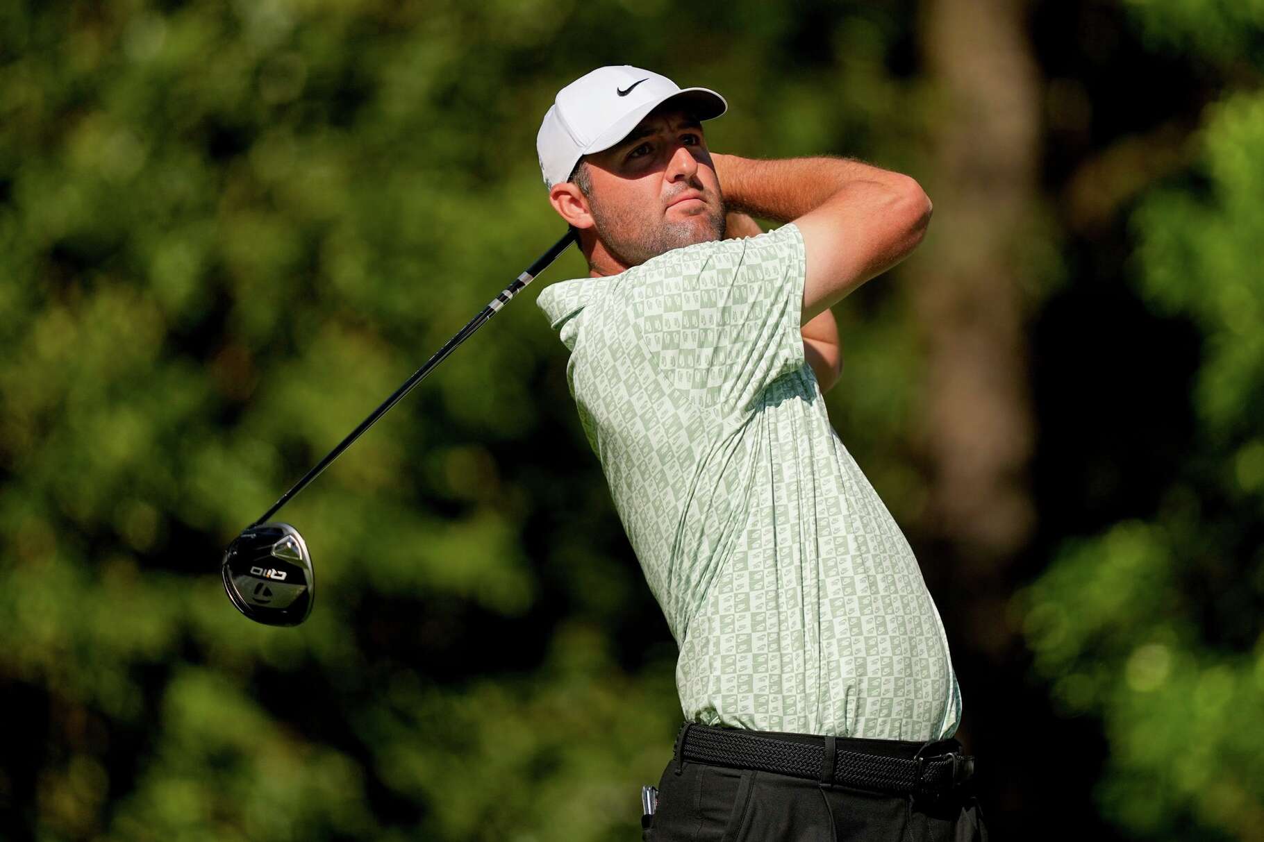 Scottie Scheffler watches his tee shot on the 11th hole during the first round of the Masters golf tournament at the Augusta National Golf Club, Thursday, April 9, 2026, in Augusta, Ga.