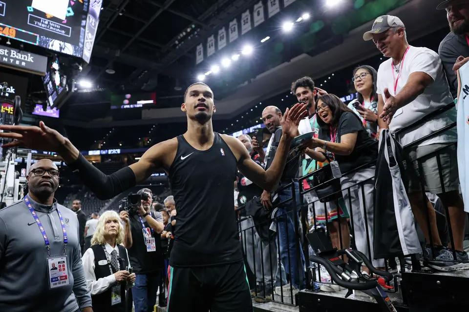 After warming up, San Antonio Spurs forward Victor Wembanyama high-fives fans as he walks to the locker room before a home game against the Dallas Mavericks at Frost Bank Center in San Antonio, Friday, April 10, 2026.