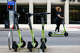 Cassie Holl of Dallas rides a scooter along Main St. on Wednesday, May 24, 2023 in downtown Dallas.