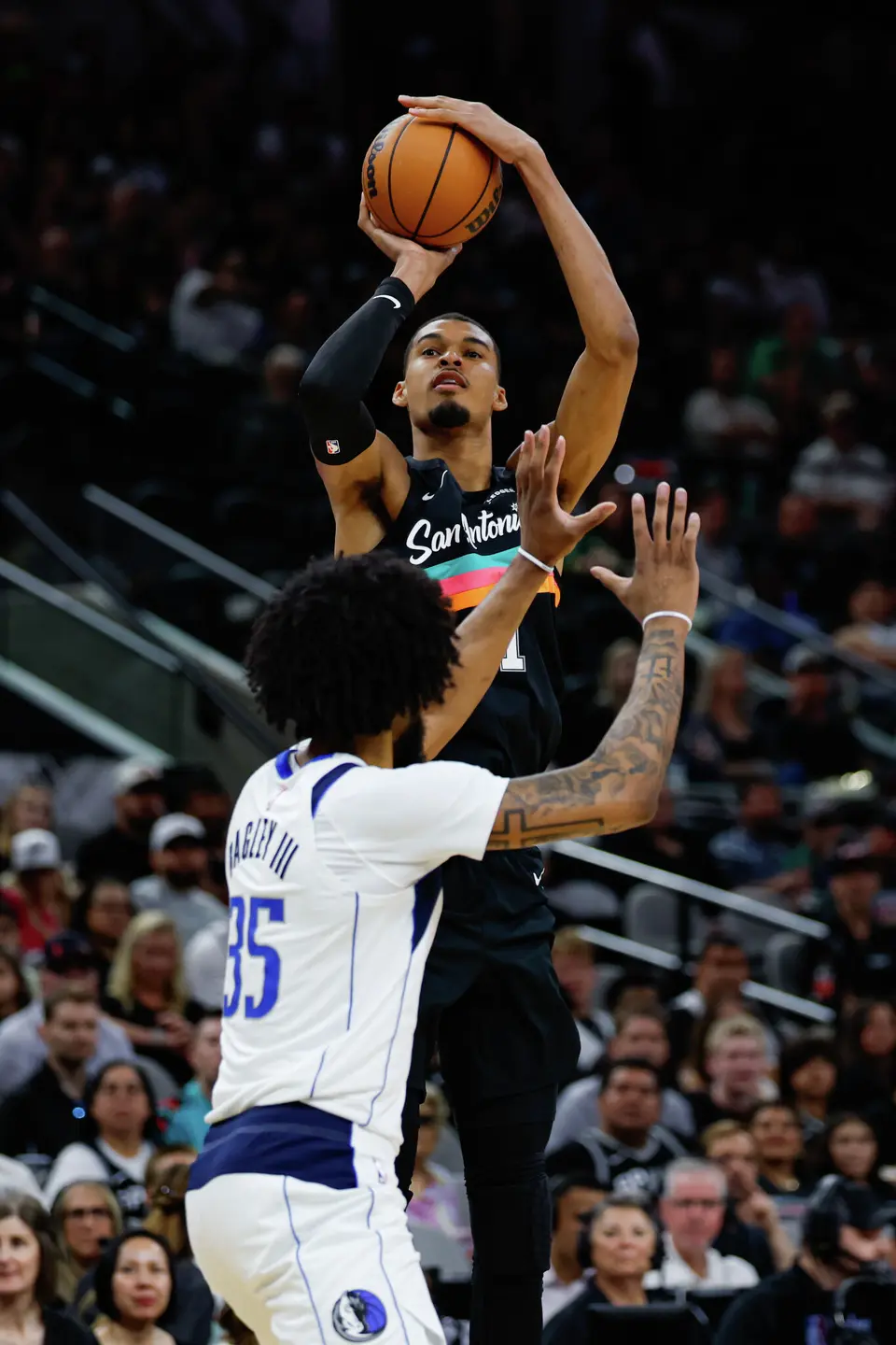 San Antonio Spurs forward Victor Wembanyama (1) shoots a 3-pointer over Dallas Mavericks forward Marvin Bagley III (35) during the first quarter at Frost Bank Center in San Antonio, Friday, April 10, 2026. The Spurs won 139-120.
