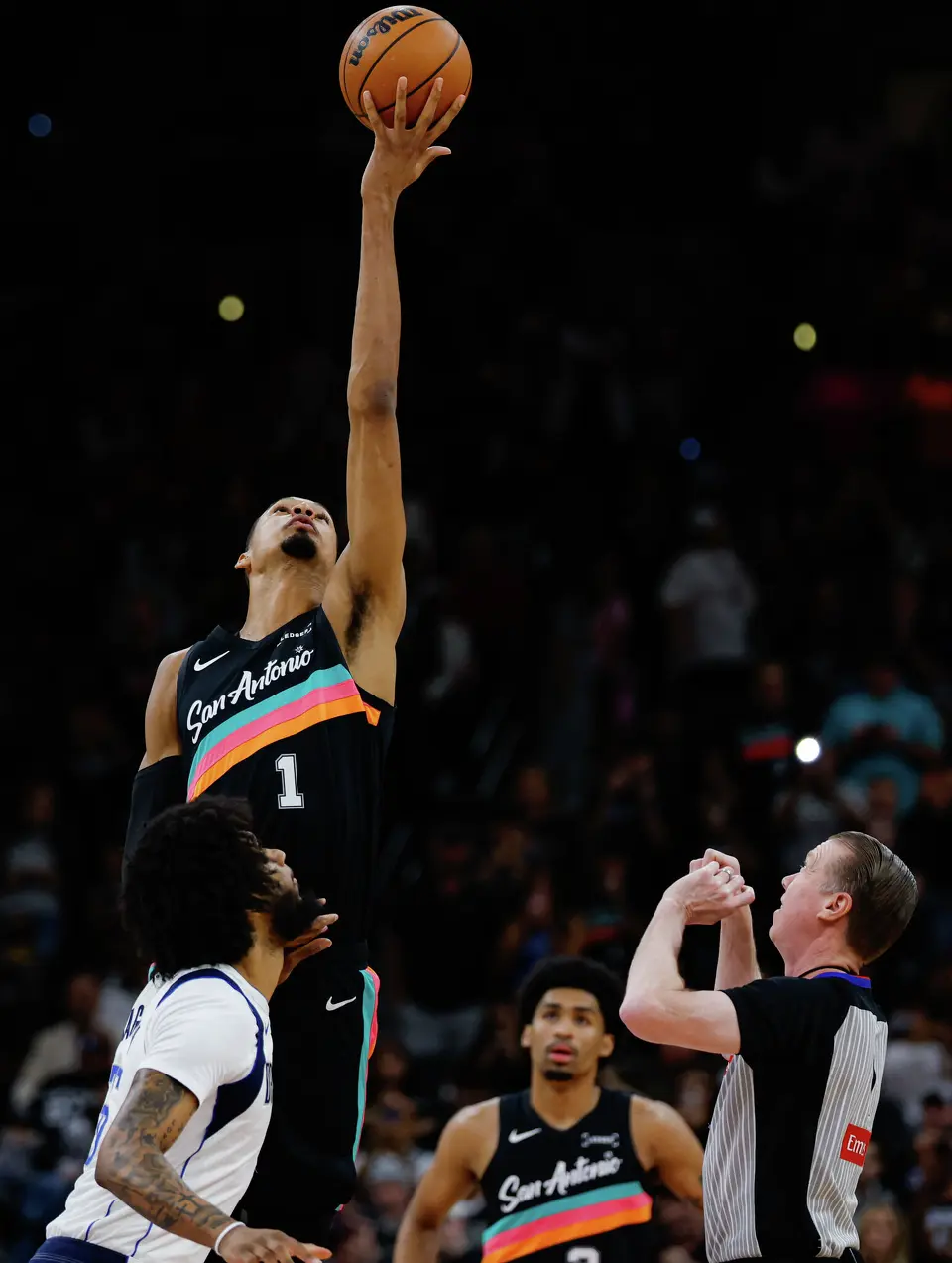 San Antonio Spurs forward Victor Wembanyama (1) wins the tip-off over Dallas Mavericks forward Marvin Bagley III (35) during an NBA game at Frost Bank Center in San Antonio, Friday, April 10, 2026. The Spurs won 139-120.