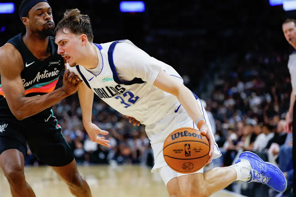 Dallas Mavericks forward Cooper Flagg (32) drives past San Antonio Spurs forward Harrison Barnes (40) during the fourth quarter at Frost Bank Center in San Antonio, Friday, April 10, 2026. The Spurs won 139-120.