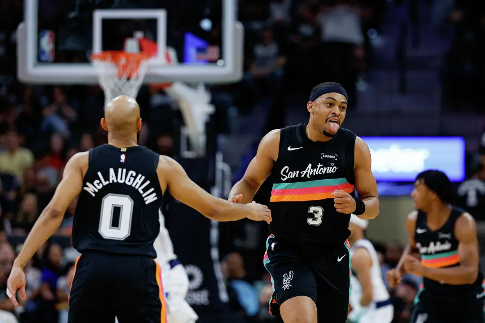 San Antonio Spurs guard Jordan McLaughlin (0) slaps hands with forward Keldon Johnson (3) after Johnson made a basket over the Dallas Mavericks in the fourth quarter at Frost Bank Center in San Antonio, Friday, April 10, 2026. The Spurs won 139-120.