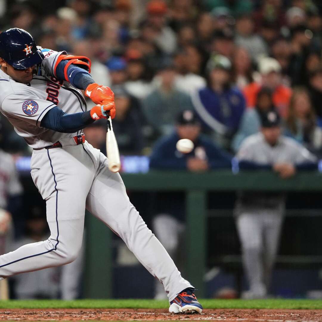 Houston Astros' Cam Smith hits a two-run single against the Seattle Mariners during the third inning of a baseball game, Saturday, April 11, 2026, in Seattle. (AP Photo/Lindsey Wasson)