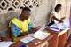Electoral officials prepare presidential ballot papers at a polling station in Cotonou, Benin, Sunday, April 12, 2026.