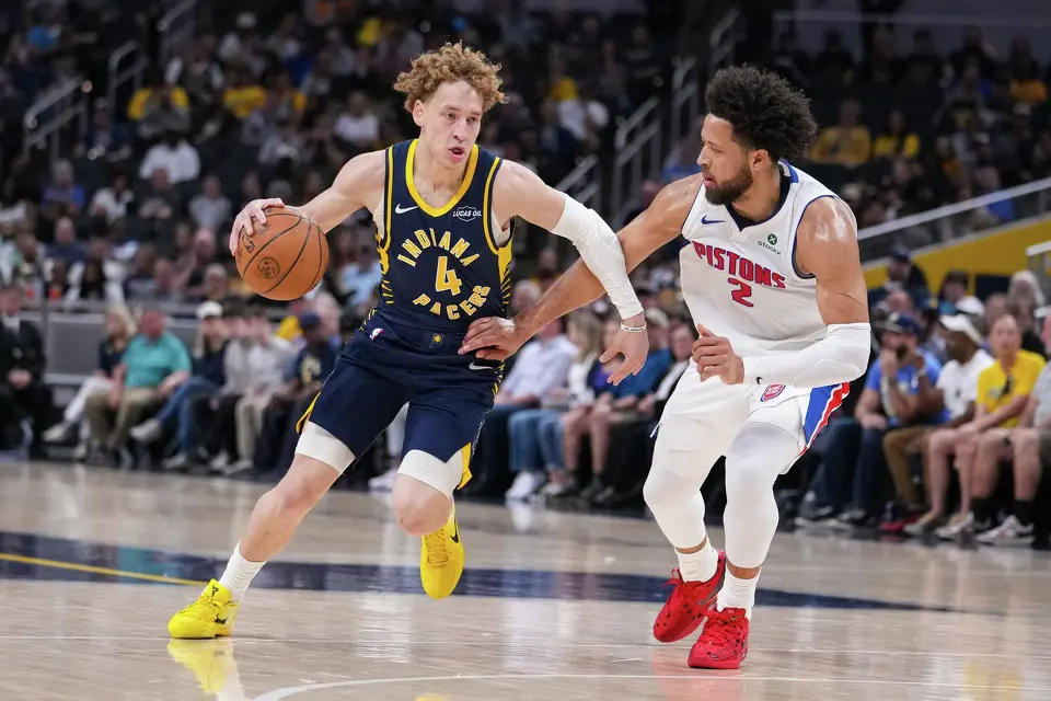 Indiana Pacers guard Taelon Peter (4) drives on Detroit Pistons guard Cade Cunningham (2) during the first half of an NBA basketball game in Indianapolis, Sunday, April 12, 2026.