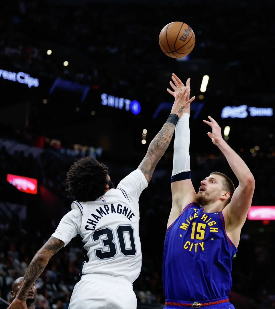Denver Nuggets center Nikola Jokic (15) shoots over San Antonio Spurs forward Julian Champagnie (30) during the second quarter at Frost Bank Center in San Antonio, Sunday, April 12, 2026.