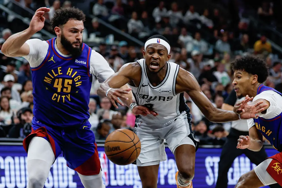 Denver Nuggets forward David Roddy (45) and guard Curtis Jones (1) guard San Antonio Spurs guard De'aaron Fox (4) at Frost Bank Center in San Antonio, Sunday, April 12, 2026. The Spurs fell to the Nuggets, 128-118.