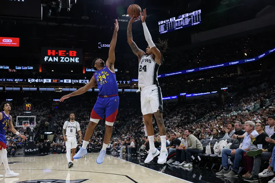 San Antonio Spurs guard Devin Vassell (24) shoots over Denver Nuggets guard Jalen Pickett (24) during the third quarter at Frost Bank Center in San Antonio, Sunday, April 12, 2026. The Spurs lost 128-118 to the Nuggets in their final regular-season game.