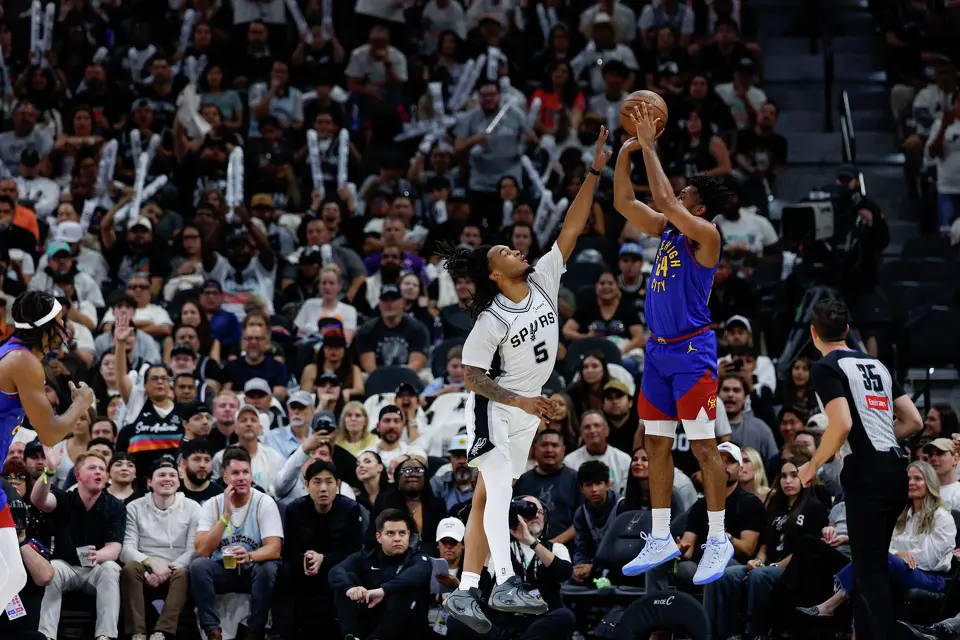 Denver Nuggets guard Jalen Pickett (24) shoots over San Antonio Spurs guard Stephon Castle (5) during the fourth quarter at Frost Bank Center in San Antonio, Sunday, April 12, 2026. The Spurs lost 128-118 to the Nuggets in their final regular-season game.