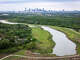 The Dallas city skyline is seen beyond the Trinity Forest wetlands on March 28, 2026.