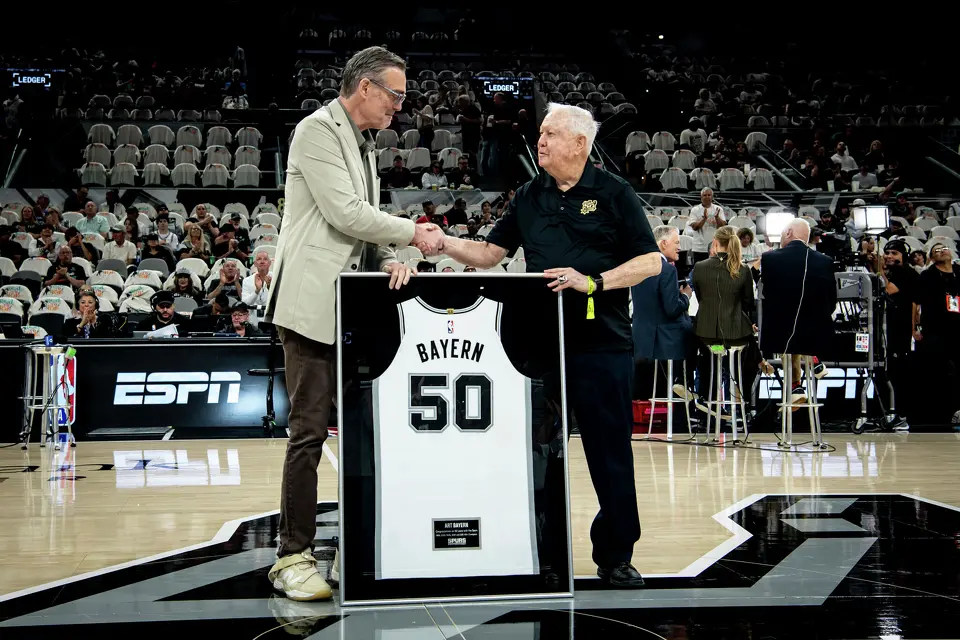 April 12, 2026, San Antonio, TX: Spurs Sports & Entertainment Chief Executive Officer R.C. Buford helps honor Art Bayern, right, before the game against the Denver Nuggets at the Frost Bank Center in San Antonio, Texas Sunday, April 12, 2026. (Photo by Reginald Thomas II/San Antonio Spurs)